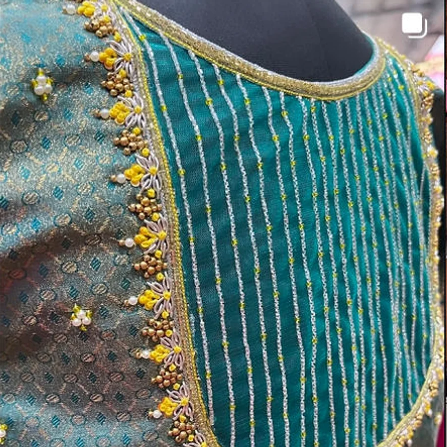 Hand embroidery on a teal blouse, silver thread and gold beadwork