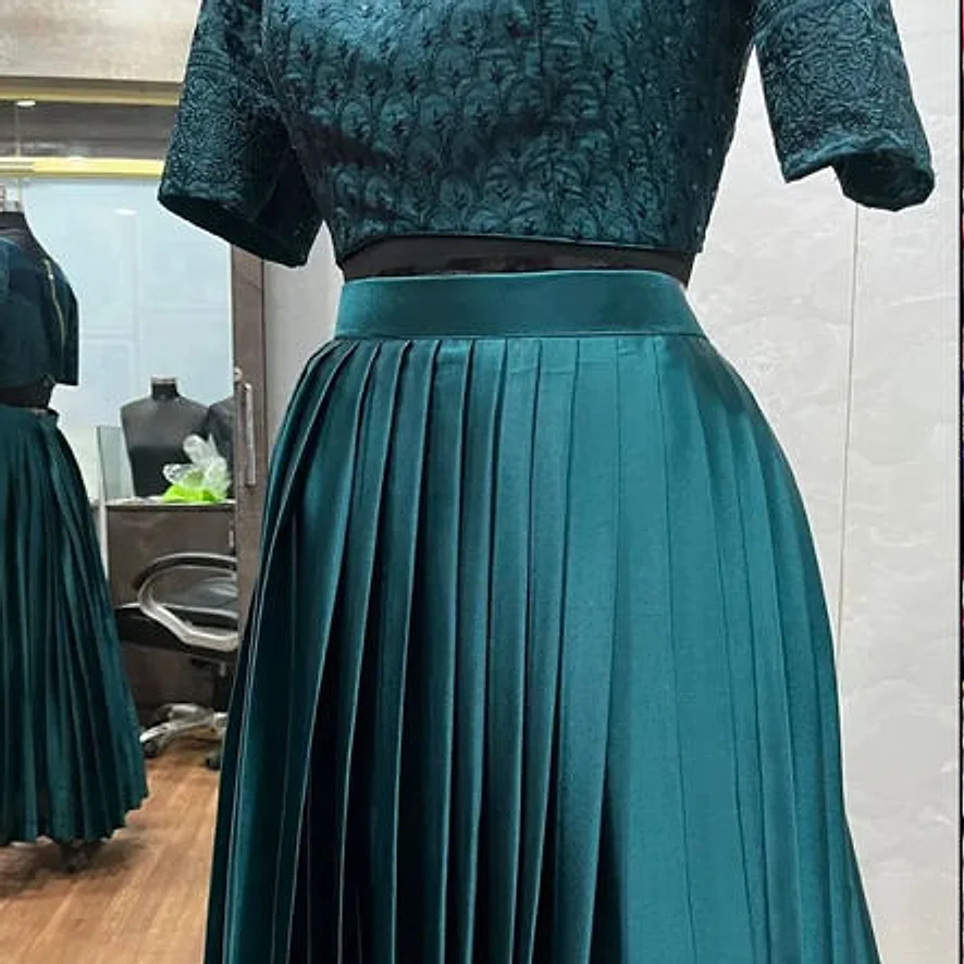 Emerald pleated lehenga with a matching brocade blouse